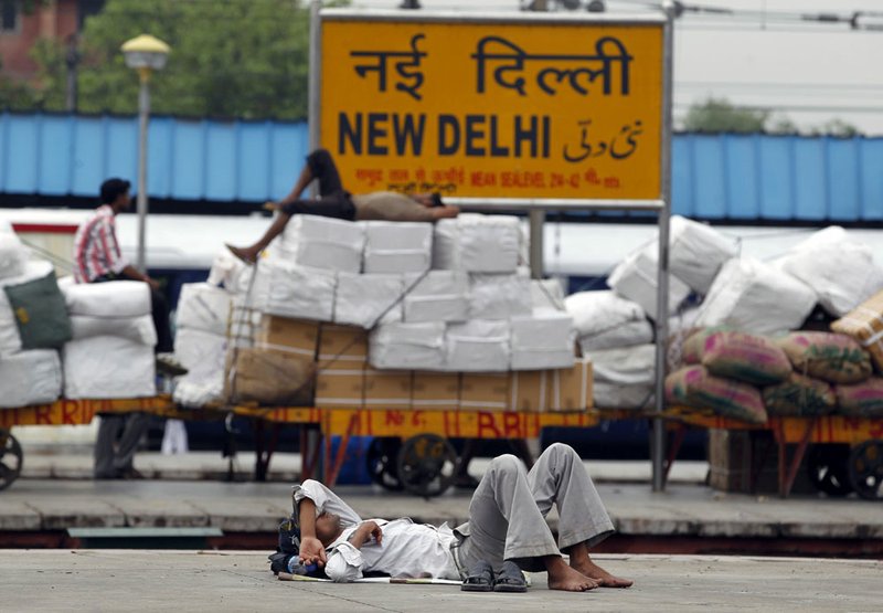 Indian laborers sleep on railway platforms Tuesday, July 31, 2012, at the New Delhi railway station after a power failure.