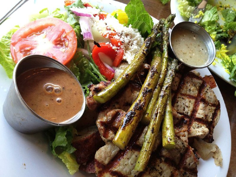 The herb-roasted pork loin with tomato chutney aeoli and grilled asparagus at the Chenal Parkway Taziki's Mediterranean Cafe
