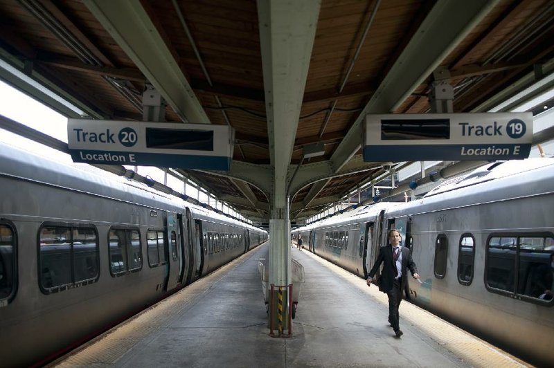 A passenger sets out to board an Amtrak Acela train at Union Station in Washington. 