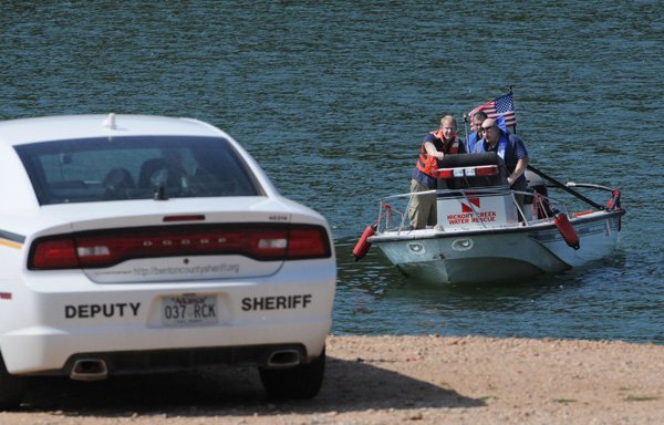 Members with the Hickory Fire Department Water Rescue Team search the water Saturday for a drowning victim in Beaver Lake near Monte Ne.
