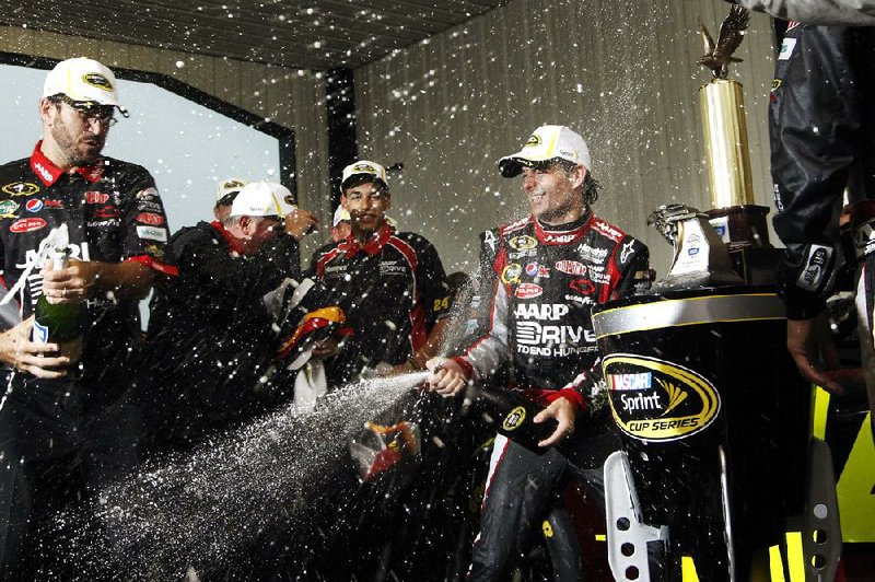 NASCAR Sprint Cup driver Jeff Gordon (right) celebrates with his crew after winning Sunday’s rain-shortened Pennsylvania 400 at Pocono Raceway in Long Pond, Pa. It was Gordon’s 86th career victory and first since September. 