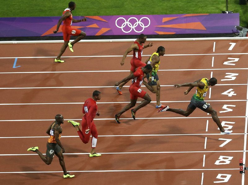 Jamaican sprinter Usain Bolt (right) crosses the finish line in 9.63 seconds, winning a gold medal and setting an Olympic record in the men’s 100-meter final Sunday in London. Jamaica’s Yohan Blake (center) was second, followed by Americans Justin Gatlin and Tyson Gay (top). 