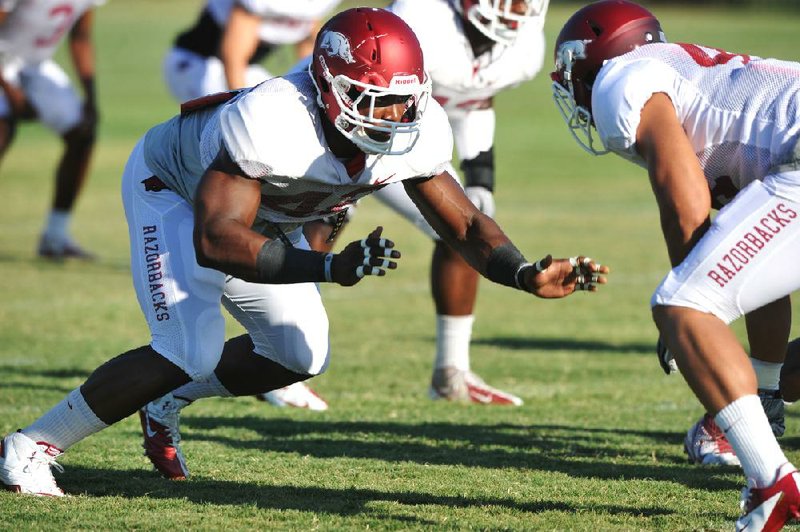 Defensive end Chris Smith (left) is one of five Arkansas defensive linemen who started at least three games last season. Arkansas is trying to improve after ranking No. 9 in the SEC in defense in 2011. 