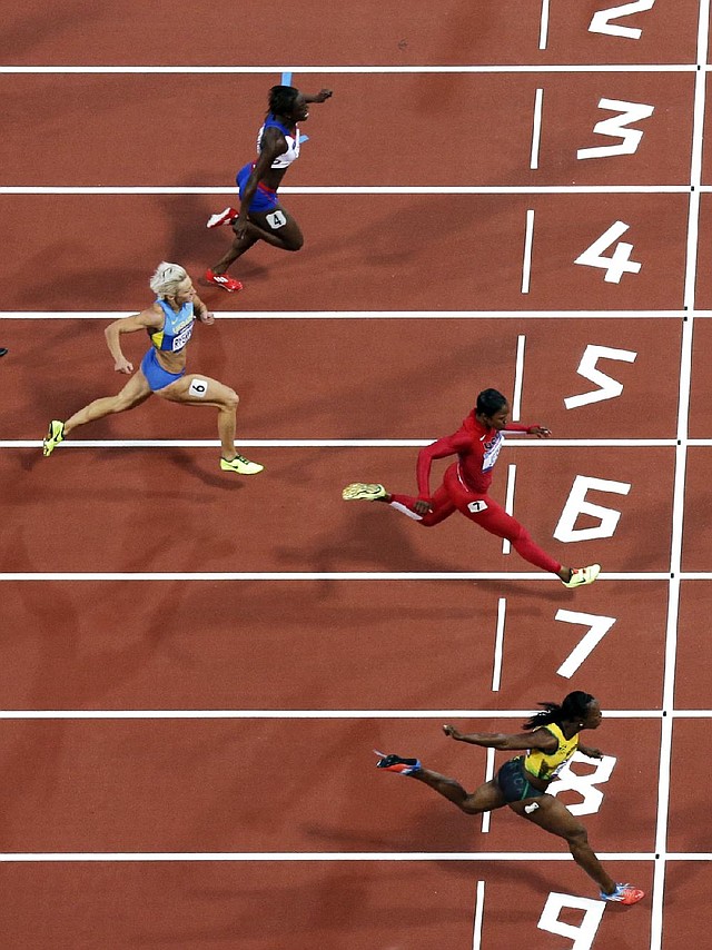 Former Arkansas Razorbacks runner Veronica Campbell-Brown of Jamaica (bottom) edged American Carmelita Jeter by 0.07 seconds to win her semifinal heat in the 200 meters Tuesday in London. 