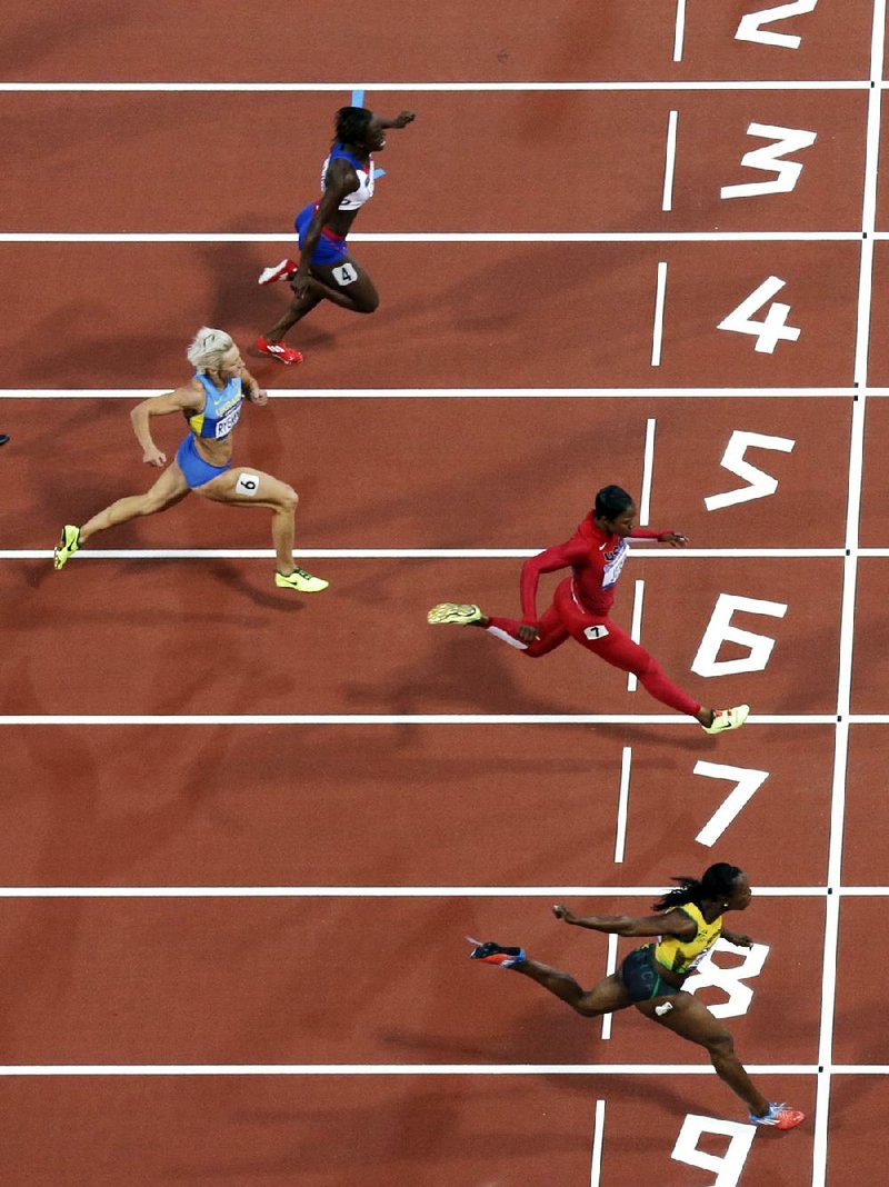 Former Arkansas Razorbacks runner Veronica Campbell-Brown of Jamaica (bottom) edged American Carmelita Jeter by 0.07 seconds to win her semifinal heat in the 200 meters Tuesday in London. 
