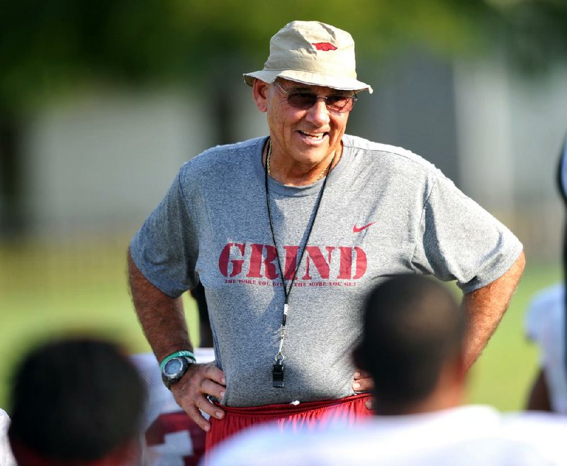 Arkansas Democrat-Gazette/MICHAEL WOODS  --08/07/2012-- University of Arkansas Head Coach John L Smith works with his team during practice Tuesday in Fayetteville.