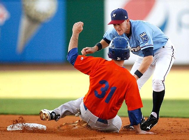 STAFF PHOTO JASON IVESTER
Midland's Anthony Aliotti slides safely into second base as the throw gets past Naturals shortstop Alex McClure on Friday, Aug. 10, 2012, in the first inning at Arvest Ballpark in Springdale.