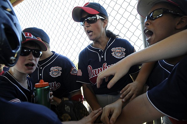 Lisa Cianflone, team manager for the Danbury, Conn., All-Stars, gets her players pumped up Friday before their opening game in the 2012 Cal Ripken World Series against Crown Point, Ind., at Memorial Park in Bentonville. 
