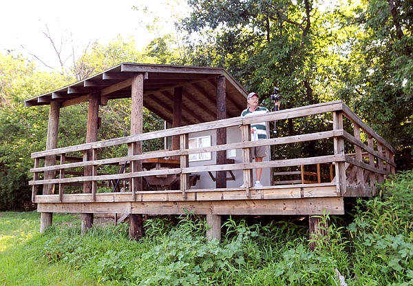Terry Stanfill, caretaker for the Eagle Watch Nature Area, watches for wildlife photo opportunities from the observation platform at the end of the Eagle Watch Trail.