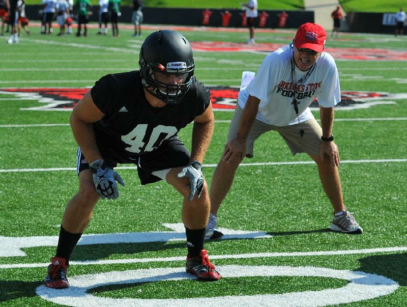 Arkansas State linebacker Nathan Herrold (left) started fall camp with a new look after an offseason spent experimenting with a new diet and workouts to strengthen his knee. Defensive coordinator John Thompson (right) said he is pleased with the results. 