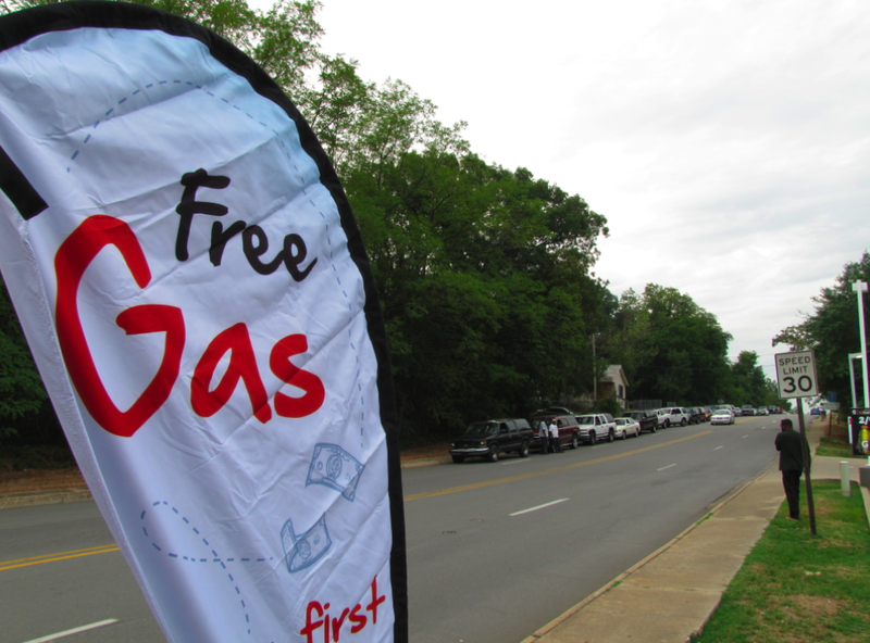 Cars line up along Bankhead Drive Wednesday to get free gas as part of a community banking promotion.