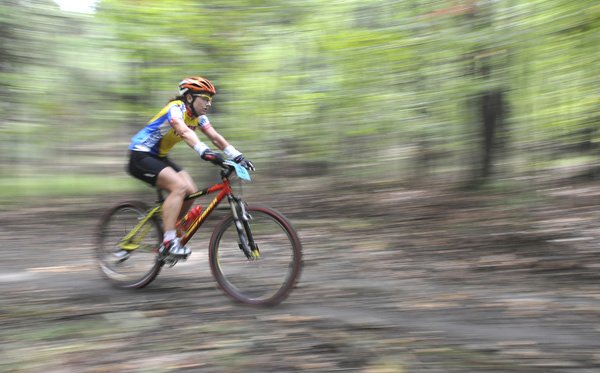 A rider wearing full-fingered bike gloves September 2011 competes during a mountain bike race at Devil’s Den State Park.