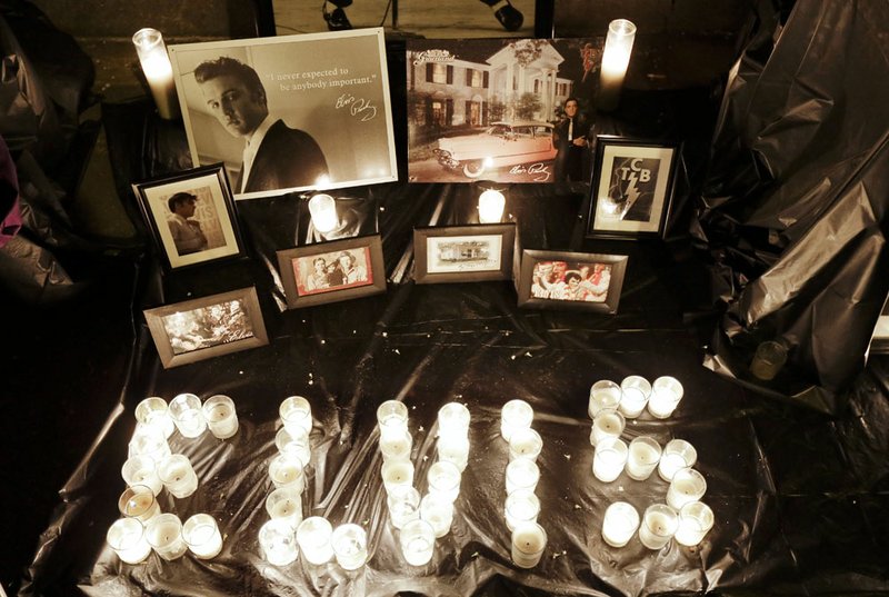 A memorial to Elvis Presley is displayed outside Graceland, Presley's Memphis home, on Wednesday, Aug. 15, 2012. Fans from around the world are at Graceland to commemorate the 35th anniversary of Presley's death. 

