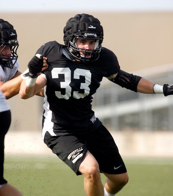 Garrett Kaufman, a Bentonville linebacker, works to get to the ball carrier during practice inside Tiger Stadium. 