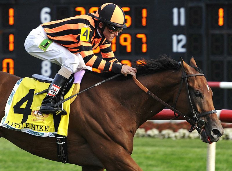 Little Mike, ridden by Ramon A. Dominguez, wins the Arlington Million horse race at Arlington Park, Saturday, Aug. 18, 2012, in Arlington Heights, Ill. (AP Photo/Jim Prisching)