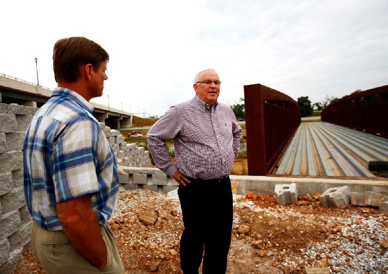 STAFF PHOTO JASON IVESTER
Rogers Planning Director Steve Glass (left) and Rogers Parks & Recreation director Barney Hayes discuss the "bridge to the future" on Tuesday, Aug. 14, 2012, located alongside I-540 in Rogers. The bridge is part of the Razorback Greenway.