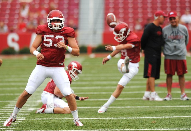 Sophomore deep snapper Alan D’Appollonio (53) is one of five key returning starters for Arkansas’ special teams, along with kicker Zach Hocker (right) and holder Brian Buehner (center). Punter Dylan Breeding and kickoff returner Dennis Johnson are also back this season. 