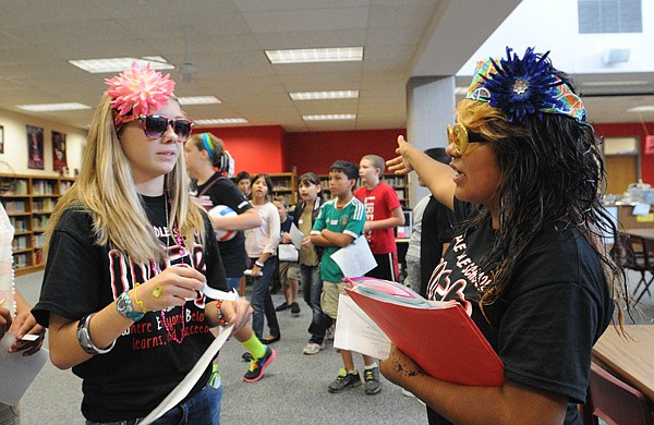 Lingle eighth-grade students Maddi Ware, left, and Selana Ramirez sport flower-girl outfits while leading new students on a tour of the school Friday Aug. 17 2012. Tour guides dressed in costume to make the event fun for incoming sixth-grade students.