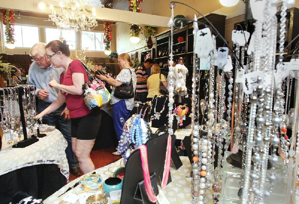 News-Times/Michael OrrellCash mob: Over twenty-five people mobbed Wreaths and More in downtown El Dorado at the start of Main Street El Dorado ash Mobon Thursday afternoon. The cash mob was put together to help provide an economic boost for local retail shops downtown.