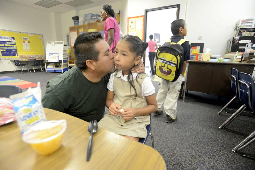Arkansas Democrat-Gazette/KAREN E. SEGRAVE --8/20/12-- Wladimir (cq) Delgado kisses his daughter Lesly Delgado goodbye on her first day of Pre-K at Baseline Elementary School on Monday morning. Of the 325 students enrolled at Baseline elementary, 44% are Hispanic or Latino. Baseline has the highest ESL population in the district - for the first time Baseline has a bi-lingual staff specialist and a bi-lingual paraprofessional... and the majority of staff is ESL endorsed or has special training to meet the needs of Spanish speaking patrons and students.