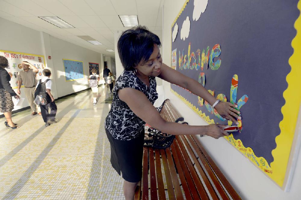 Arkansas Democrat-Gazette/KAREN E. SEGRAVE --8/20/12-- Marie Smith, a first grade teacher at Baseline Elementary School staples the final letters of a "Welcome Back" sign onto a bulletin board on Monday morning. Of the 325 students enrolled at Baseline elementary, 44% are Hispanic or Latino. Baseline has the highest ESL population in the district - for the first time Baseline has a bi-lingual staff specialist and a bi-lingual paraprofessional... and the majority of staff is ESL endorsed or has special training to meet the needs of Spanish speaking patrons and students.