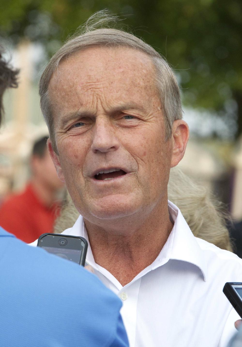 In this Thursday, Aug. 16, 2012 photograph, Rep. Todd Akin, R-Mo., talks with reporters while attending the Governor's Ham Breakfast at the Missouri State Fair in Sedalia, Mo. Akin was keeping a low profile, Monday, Aug. 20, 2012, a day after a TV interview in which he said that women's bodies can prevent pregnancies in