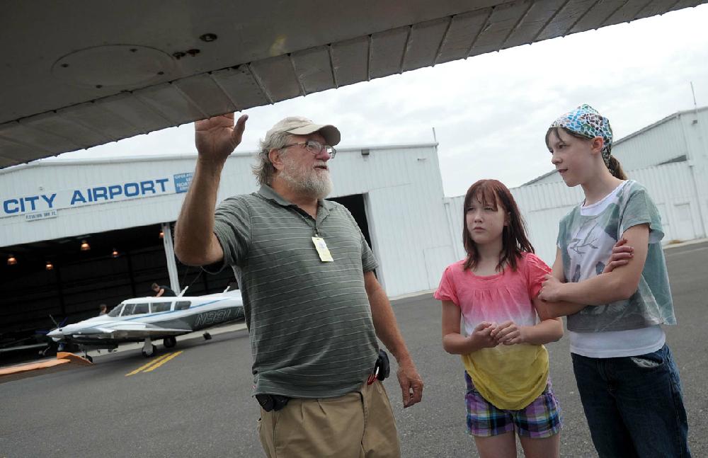 Private pilot Timothy Nyemscek, left, of Emmaus, shows Ilene Brudnicki, 9, of Forks Township, center, and her sister, Alison Brudnicki, 12, of Forks Township, how to do a pre-flight check of his 1969 Cessna C-150 Monday morning, Aug. 20, 2012 at the Queen City Airport in Allentown, Pa. The Lehigh Northampton Airport Authority was hosting the event in observance of National Aviation Day. (AP Photo/The Express-Times, Matt Smith)