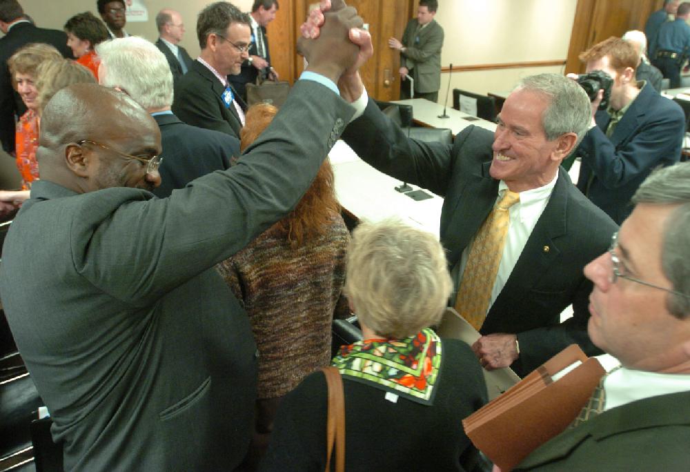 Arkansas Democrat-Gazette/STEVE KEESEE  3/23/05 Chief Operating Officer of Central Arkansas Water Jim Harvey (right) and Odies Wilson, III, with the City of Little Rock, clasp hands after SB230 failed to pass in the House Committee on City, County and Local Affairs Wednesday.