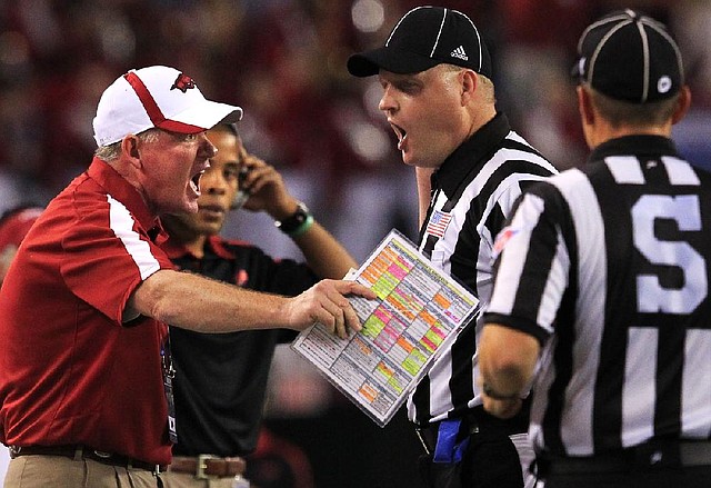Arkansas Democrat-Gazette/BENJAMIN KRAIN --1/6/12--
Bobby Petrino argues a call with the officials after a penalty on a field goal which forced the Razorbacks to punt instead.
