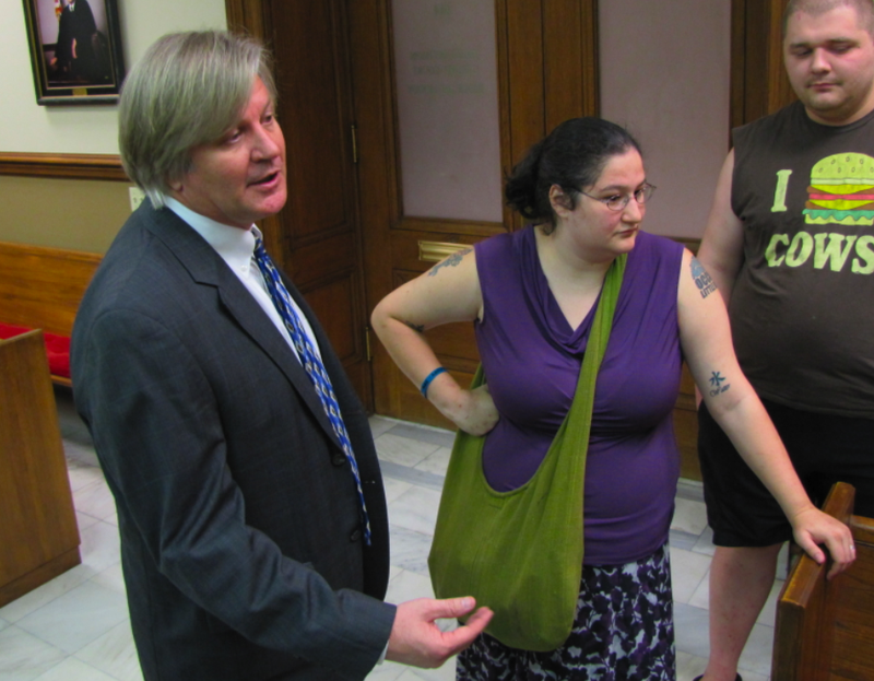 Attorney David Couch speaks beside Occupy Little Rock member Kaitlin Lott after a hearing Friday in Pulaski County Circuit Court.