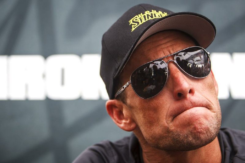 FILE - This April 1, 2012 file photo shows seven-time Tour de France champion Lance Armstrong grimacing during a news conference after the Memorial Hermann Ironman 70.3 Texas triathlon in Galveston, Texas. A federal judge in Austin, Texas, has thrown out Lance Armstrong's lawsuit against the U.S. Anti-Doping Agency, an attempt to stop the drug case against the seven-time Tour de France winner.    (AP Photo/Houston Chronicle, Michael Paulsen, File ) MANDATORY CREDIT