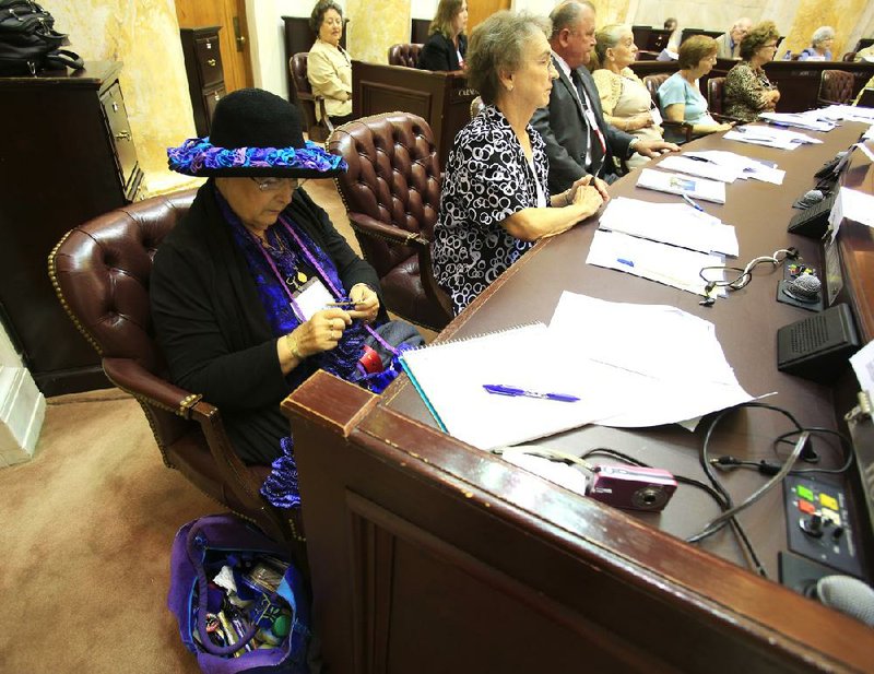 Arkansas Democrat-Gazette/ STATON BREIDENTHAL --8/23/12--Lee Carlson of Mt. Home knits a hat band Thursday as she listens to bills being presented on the House floor during the biennial Silver-Haired Legislature. The session is a mock legislature of delegates 60 years of age and older that convenes every two years.