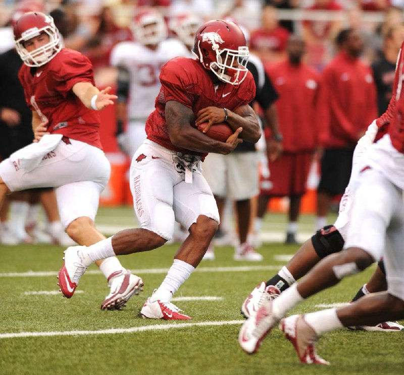 Arkansas running back Knile Davis (center), who was averaging 99.9 yards a game before he tore a ligament in his left knee last season, is one of several SEC running backs making a comeback from significant injuries. 