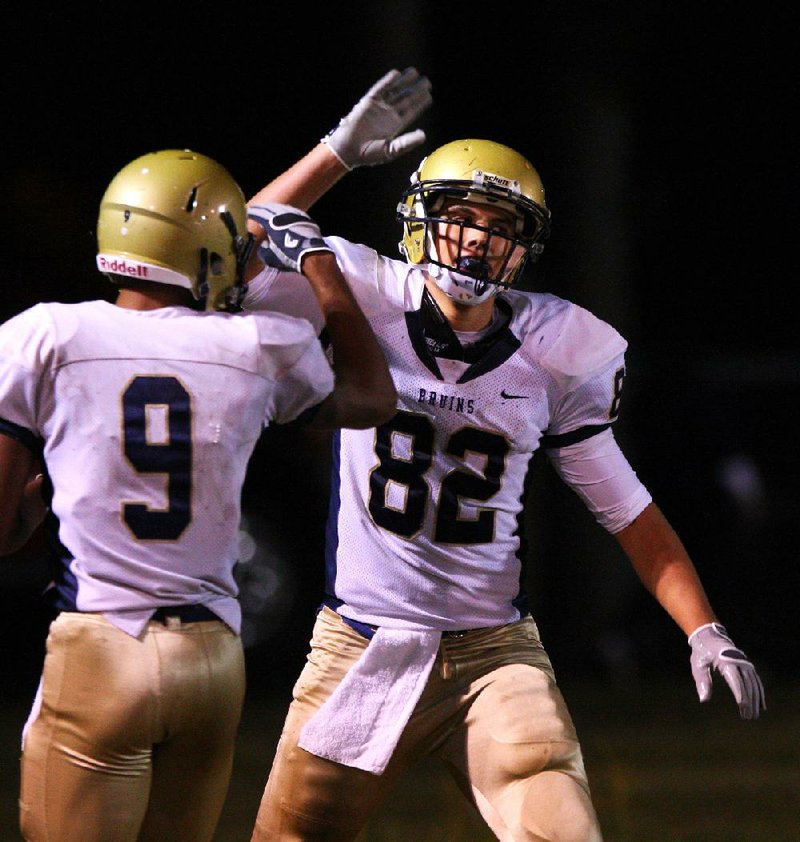 Pulaski Academy tight end Hunter Henry (82) is ranked the No. 52 recruiting prospect in the country by one rating service and is the same size as his father, Mark, an all-Southwest Conference offensive lineman at Arkansas in 1991. Earlier this year, Henry ended the recruiting process when he committed to the Razorbacks. 