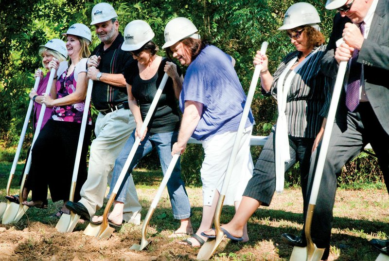 Bethlehem House Executive Director Judi Lively, center, and board members participate in Tuesday’s groundbreaking for the Conway homeless shelter’s facility. Shown, from the left, are Kay Satterwhite, Amy Kennedy, Bob Fason, Arlene Montgomery, Lively, Beth Eakin and Guy Murphy Jr. The 7,200-square-foot, $1.3 million shelter is being built down the street from the current one. It will be handicapped-accessible and have room for 35 residents, as well as eight emergency beds and administrative offices.