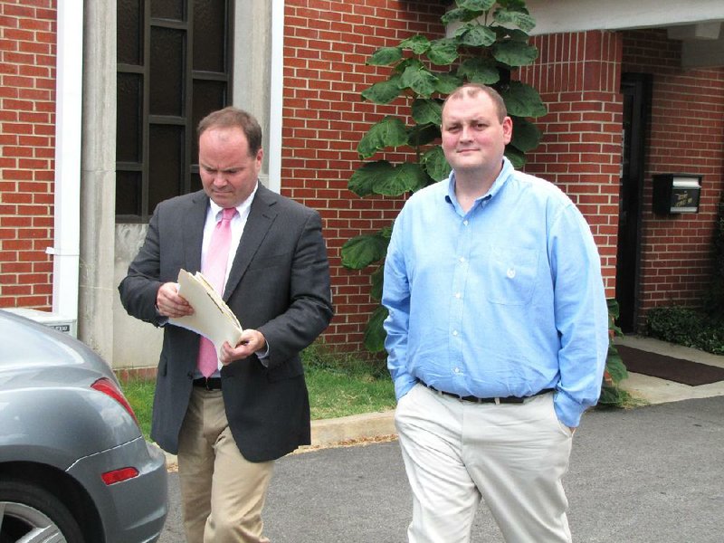 FILE - Faulkner County Administrator Jeff Johnston (right) walks out of court in Conway  with his attorney, Joe Don Winningham on Aug. 30, 2012.