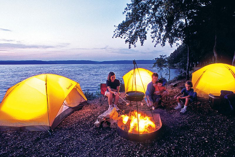 Campers at Lake Dardanelle State Park enjoy the ambiance of a campfire and tents illuminated inside with safe, efficient battery lanterns.
