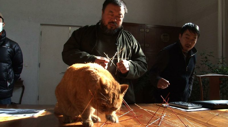 Chinese conceptual artist and political provocateur Ai Weiwei is shown with one of his 40 cats in Alison Klayman’s documentary Ai Weiwei: Never Sorry. 
