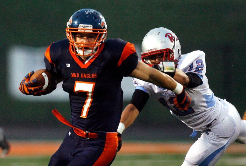 Rogers Heritage running back Brandon Gates (7) avoids Fort Smith Southside’s Garrett Wolfe in the War Eagles’ 20-19 victory Friday in Rogers. Video available at arkansasonline.com/videos. 