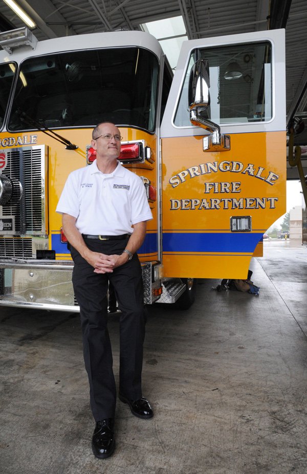 Springdale Fire Chief Mike Irwin sits Friday in the bay of Station No. 1 after his first week as the new fire chief. 