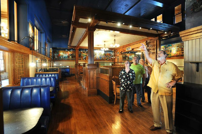 NWA Media/ANDY SHUPE
Fayetteville Realtor Mark Risk, right, points out details inside the dining area of the Old Post Office building Saturday, Sept. 1, 2012, for, from left, Barbara Pryor, Archie Schaffer, executive vice president of corporate affairs for Tyson Foods, and former Sen. David Pryor during a tour of the building on the Fayetteville downtown square.