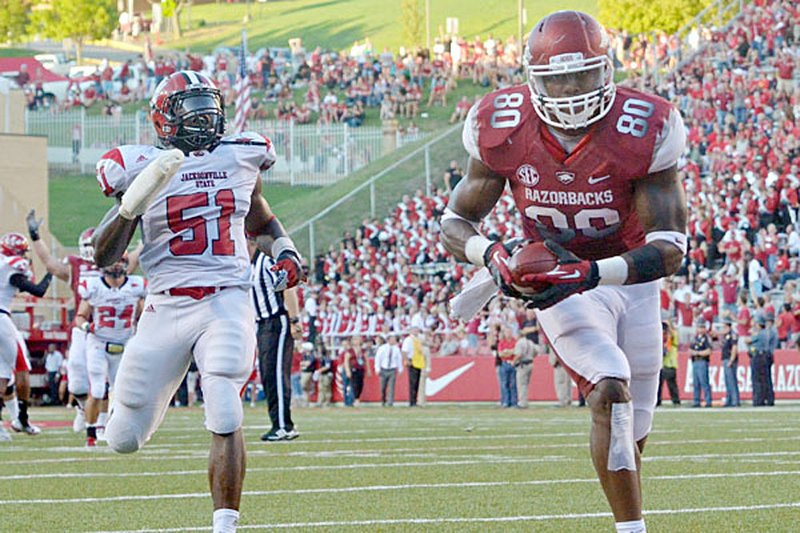 Arkansas tight end Chris Gragg scores a second-quarter touchdown on a 30-yard pass from quarterback Tyler Wilson as Jacksonville State defender Rashad Smith falls behind. The touchdown pulled the Razorbacks into a 14-14 tie with the Gamecocks. Gragg finshed the game with 7 catches for 110 yards and 2 touchdowns. 