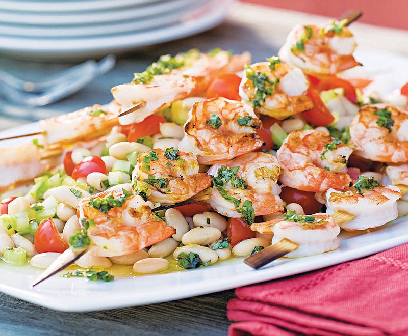 Grilled Shrimp Skewers Over White Bean Salad combines two dishes that are great separately but even better together. Also a great combination is the salad with skewered, and grilled scallops.