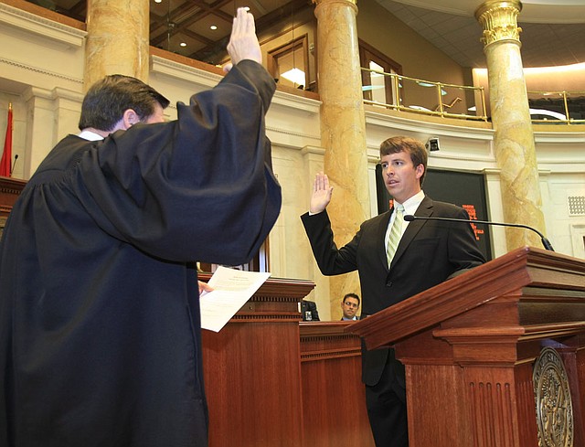 Hudson Hallum (right), D-Marion, is sworn in as the District 54 representative July 21, 2011, in the House Chamber by Arkansas Supreme Court Chief Justice Jim Hannah.