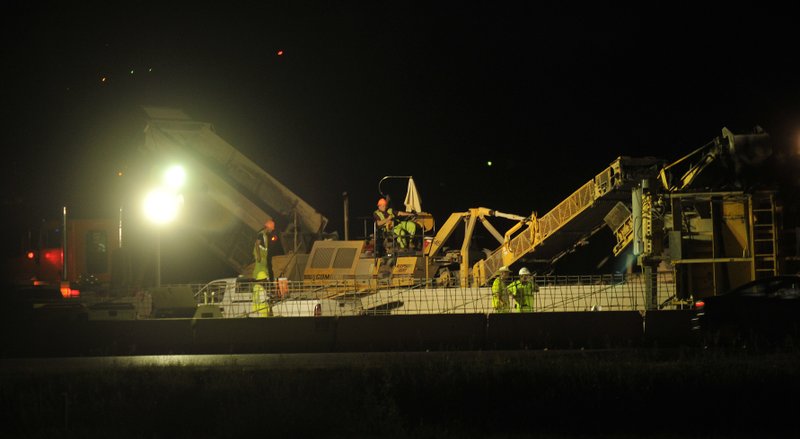 Construction crews work Tuesday evening putting in a new concrete barrier on interstate 540 in Fayetteville between the Wedding exit and MLK Jr Exit. The stretch will include the addition of another traffic lane for northbound and southbound traffic.