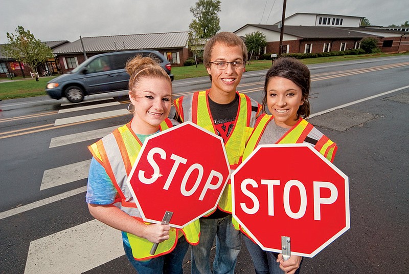 From the left, Erika Hampton, Tyler Hagerty and Megan Foote are seniors at Harmony Grove High School and serve as crossing guards.