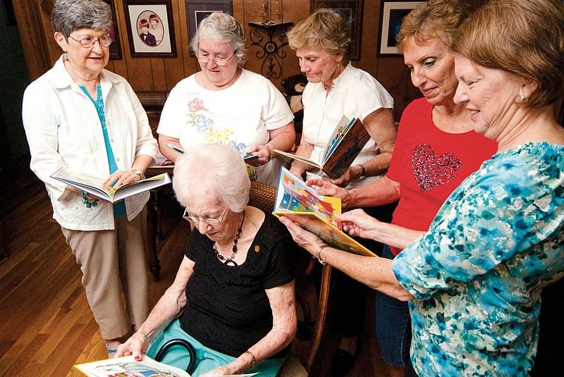 Standing from the left, Dixie Smith, Elizabeth Waldrip, Charlie Cole Chaffin, Carolyn Hoggard and Diana McWilliams, and Mildred Westbrook, seated, look at some of the children’s books distributed by Imagination Library. The women are members of the Mu Chapter of Delta Kappa Gamma, an international organization for educators.