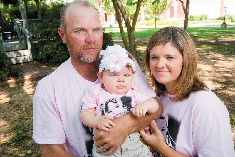 Ken and Samantha Holland of Damascus hold their 7-month-old daughter, Preslee, who has been in and out of the hospital since she was born. Extensive testing is ongoing, but the Hollands were told last week that chances are that Preslee has a fatal disorder. A fundraiser for the family, set to begin at 4 p.m. Saturday at the Damascus Community Building, will include a barbecue dinner, live entertainment, and live and silent auctions. Preslee’s Prayer Warriors T-shirts, which family members are wearing, are also for sale.