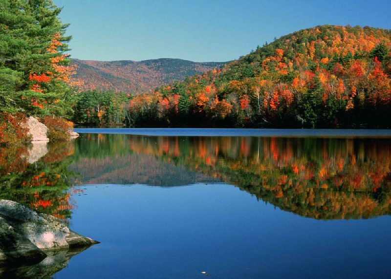 Foliage is twice as beautiful when reflected in lakes such as Perch Pond in Campton, N.H., one of the loveliest areas in New England for fall color. 