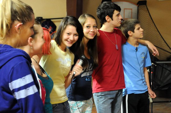 Savannah Breyfogle, 17, from left, Shelby Parsley, group leader, Summer Eastres, 16, Angelica Morales, 15, Tea Lokmer, 15, Nathan Sypult, 15, and Kyler Thurman, 15, all Friendship Church high school youth group members, gather together to sing during a group meeting Wednesday at the church in Springdale. The church is participating in National Back To Church Sunday. 